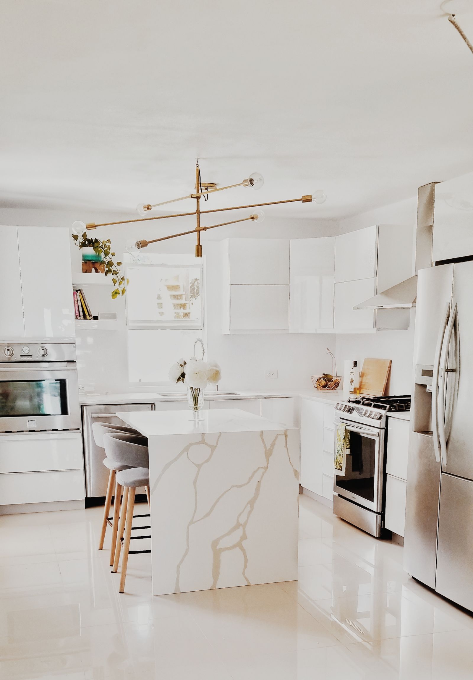 Bright American-style kitchen with a white island and stainless steel appliances